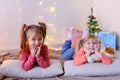 Funny little girls laugh and talk, posing lying on floor and on Royalty Free Stock Photo