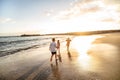 Lovely little kids playing at the beach. Cute boy and girls have fun together, running on the sand  Childhood Royalty Free Stock Photo