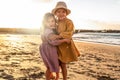 Lovely little sisters having fun at the beach, sunset summer time. A lot of copy space. Travel Royalty Free Stock Photo
