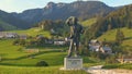 Lush landscape surrounds bronze life-size statue of Ivan Grohar Slovene painter.