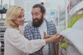 Lovely mature couple buying new pillows