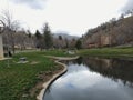 Memory Grove Park views of Waterfalls and streams leading into a small pond or lake surrounded by walking paths and trees in Salt