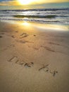 A love message I love you written on the sandy beach. Royalty Free Stock Photo