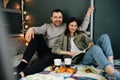 Lovely middle aged couple having a breakfast in a bed and reading a book Royalty Free Stock Photo