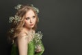 Lovely model woman with flowers on black background