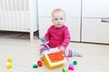 Lovely 10 months baby girl plays house shape sorter