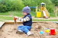 Lovely 21 months baby playing with sand