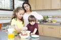 Lovely Mother and her children having breakfast Royalty Free Stock Photo