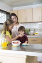 Lovely Mother and her children having breakfast Royalty Free Stock Photo