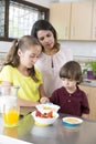 Lovely Mother and her children having breakfast Royalty Free Stock Photo