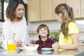 Lovely Mother and her children having breakfast Royalty Free Stock Photo