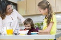 Lovely Mother and her children having breakfast Royalty Free Stock Photo