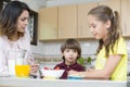 Lovely Mother and her children having breakfast Royalty Free Stock Photo