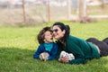 Lovely mother and son with bunnys in grass