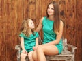 Lovely mother and little daughter in dress