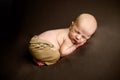 Lovely newborn baby boy sleaping toshie up pose