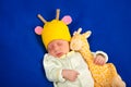 Lovely newborn baby boy sleeping on a blue blanket with little toy Royalty Free Stock Photo