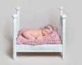 Lovely newborn baby girl sleeps on the crib Royalty Free Stock Photo