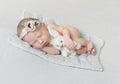 Sleeping baby girl with toy on a knitted blanket Royalty Free Stock Photo