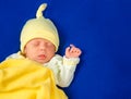 Lovely newborn little boy sleeping on a blue blanket. Baby goods packaging