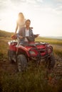 Lovely newlyweds driving quad together Rural wedding concept
