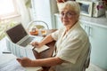 Lovely old woman filling out taxes form at home Royalty Free Stock Photo