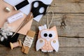 Lovely owl Christmas tree ornament made from felt. Scissors, thread, needle, thimble, felt sheets, waxed cord Royalty Free Stock Photo