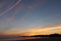 Lovely panoramic view just before sunrise of silhouette of deux jumeaux in colorful summer sky on a sandy beach