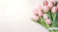 Lovely pastel pink tulips bunch, floral border at light stone background, top view. Layout for springtime holidays. Royalty Free Stock Photo