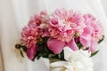 Lovely peony bouquet in sunny light on rustic wooden window sill. Stylish pink and white peonies in vase. Hello spring. Happy