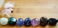 Rainbow Healing Crystals on wood table. Natural lighting with macro lens, rainbow stones. Clear Quartz, Pink Calcite, Jasper, Calc Royalty Free Stock Photo