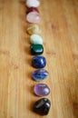 Rainbow Healing Crystals on wood table. Natural lighting with macro lens, rainbow stones. Clear Quartz, Pink Calcite, Jasper, Calc Royalty Free Stock Photo