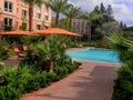 Lovely pool and red umbrellas and chairs in a new apartment complex