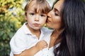 Lovely portrait of a beautiful mother kissing her little son. Close up of a young brunette female face touching to her cute child Royalty Free Stock Photo