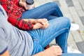 Lovely portrait of a young couple. They are sitting on the bench, embracing and kissing. Royalty Free Stock Photo