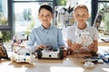 Lovely pre-teen boys posing with their robots Royalty Free Stock Photo