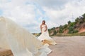 Lovely pregnant girl against a background of water and sky in a cloth. Royalty Free Stock Photo