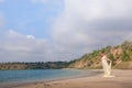 Lovely pregnant girl against a background of water and sky in a cloth. Royalty Free Stock Photo