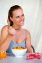 Lovely pretty girl smiling and eating at home