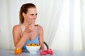 Lovely pretty woman smiling and eating at home