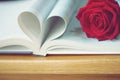 Lovely red color rose on book roll into heart shape, soft color tone, sweet valentine presentation concept