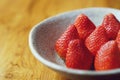 Lovely red fresh ripe strawberry in bowl on wooden table, copy space Royalty Free Stock Photo