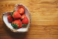 Lovely red fresh ripe strawberry in heart shape bowl on wooden table, copy space Royalty Free Stock Photo