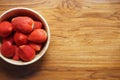 Lovely red fresh ripe strawberry in wood bowl on wooden table, copy space Royalty Free Stock Photo