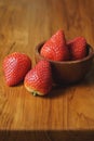 Lovely red fresh ripe strawberry in wood bowl on wooden table, copy space Royalty Free Stock Photo