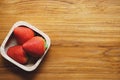 Lovely red fresh ripe strawberry in wood bowl on wooden table, copy space Royalty Free Stock Photo