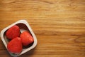 Lovely red fresh ripe strawberry in wood bowl on wooden table, copy space Royalty Free Stock Photo