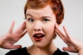 Lovely red-head young woman with surprised look Royalty Free Stock Photo