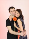 Lovely romantic couple with flower embracing