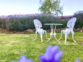 White iron table and chairs at the corner of Lavender garden. Royalty Free Stock Photo